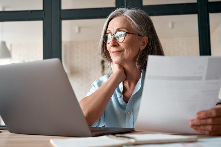 Femme travaillant derrière son ordinateur, illustrant les démarches et les conditions liées à l’obligation employeur retraite progressive.
